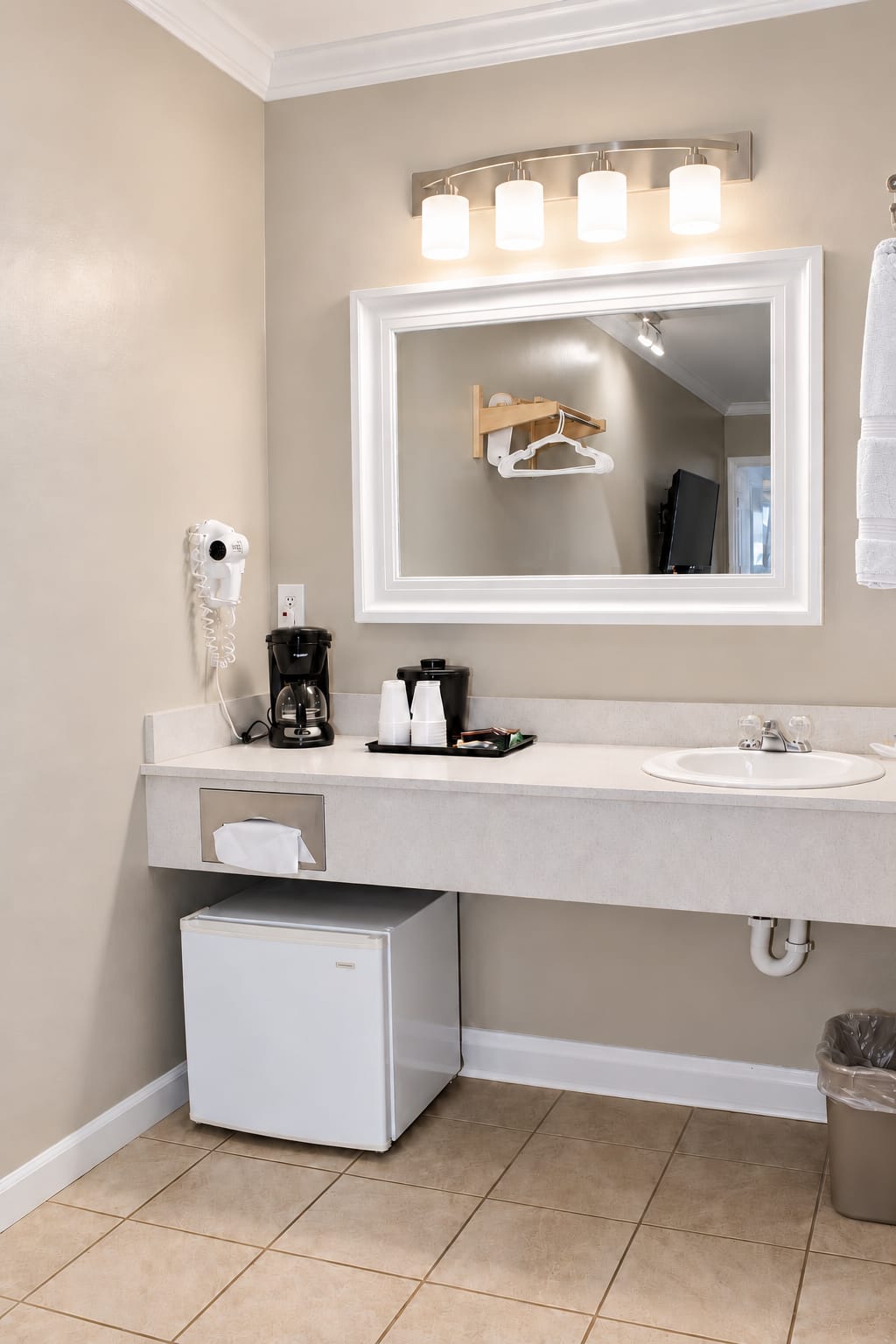 In-room vanity with mirror and lighting