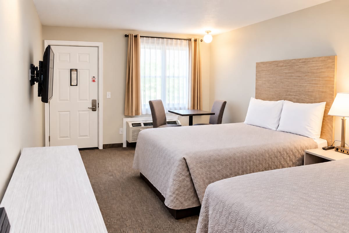 Two queen beds with nightstand and lamp